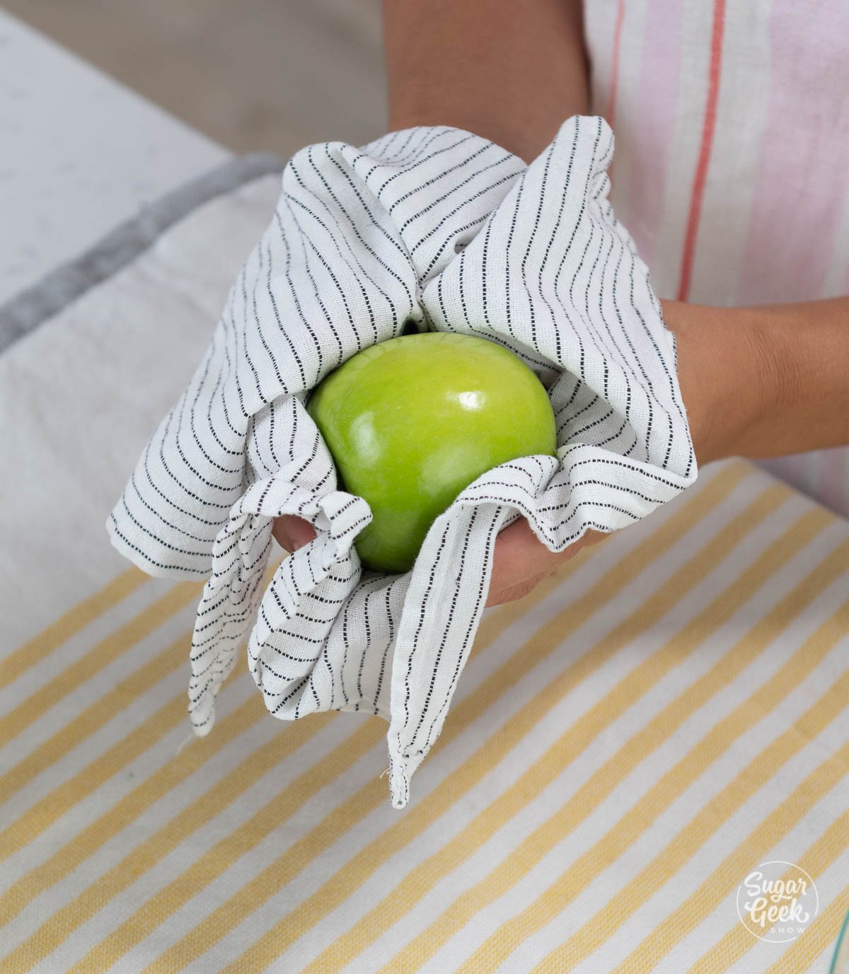 wiping apple with towel