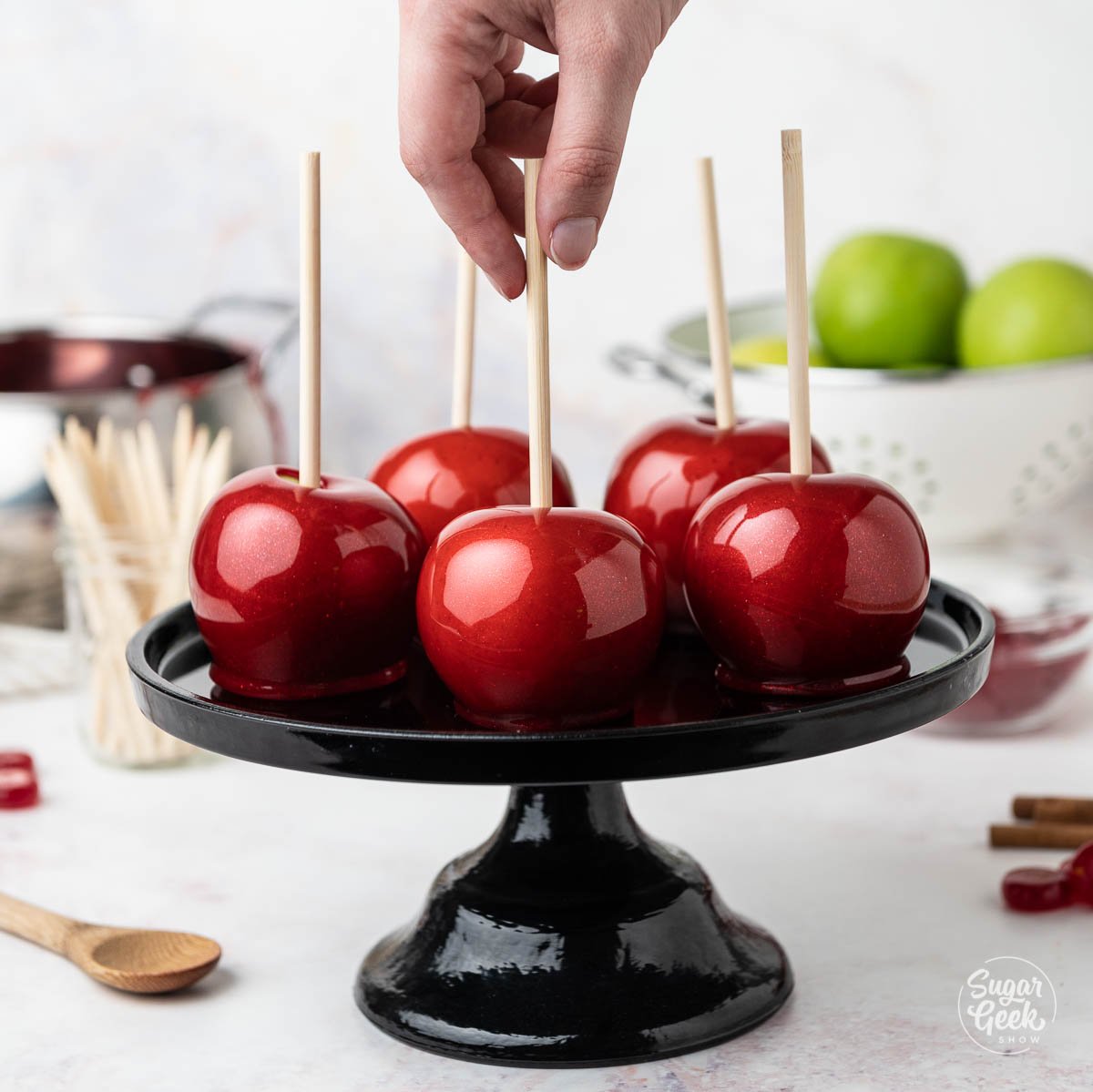 close up of candy apples on a black platter