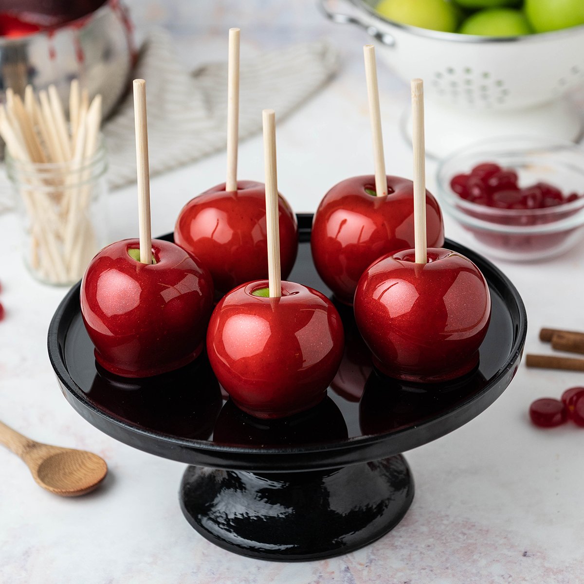 candy apples on a black platter