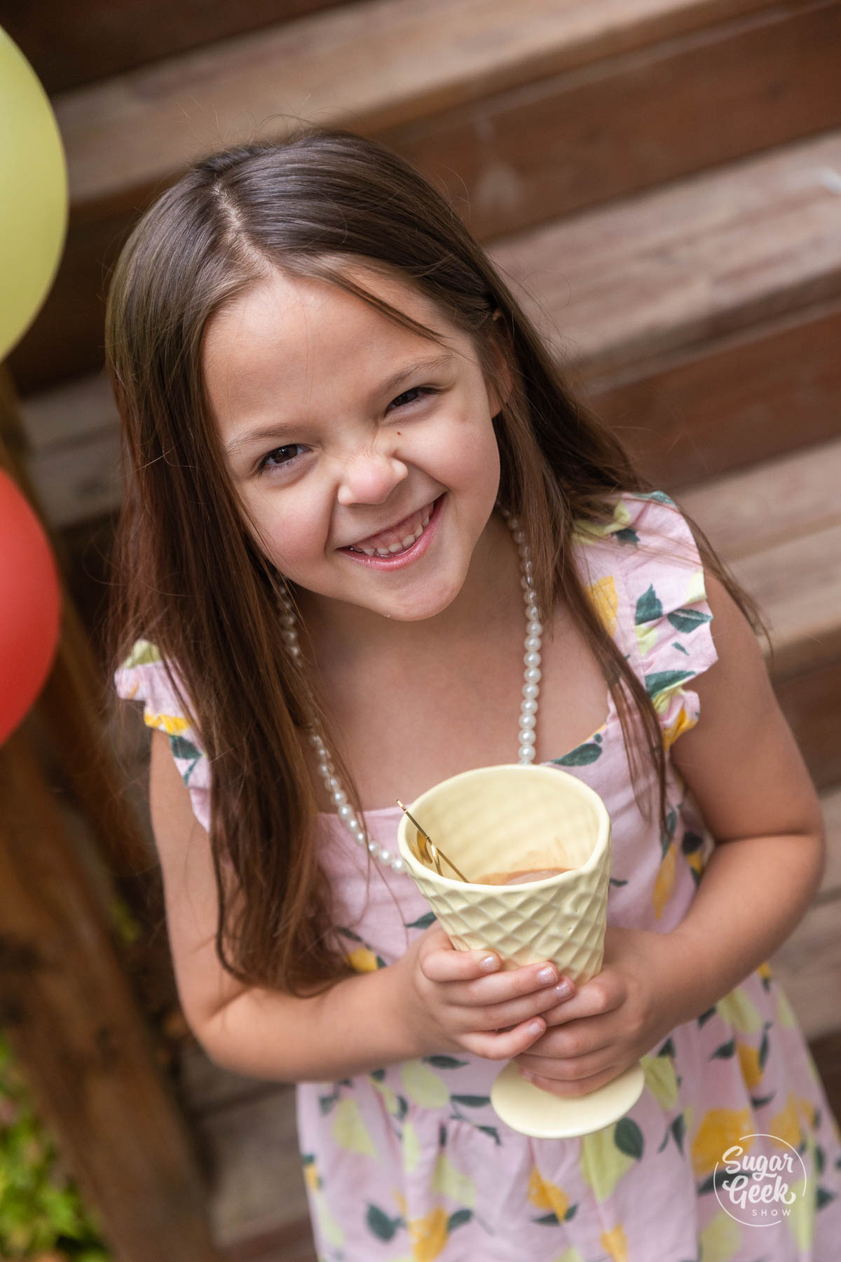 girl smiling with ceramic ice cream cone