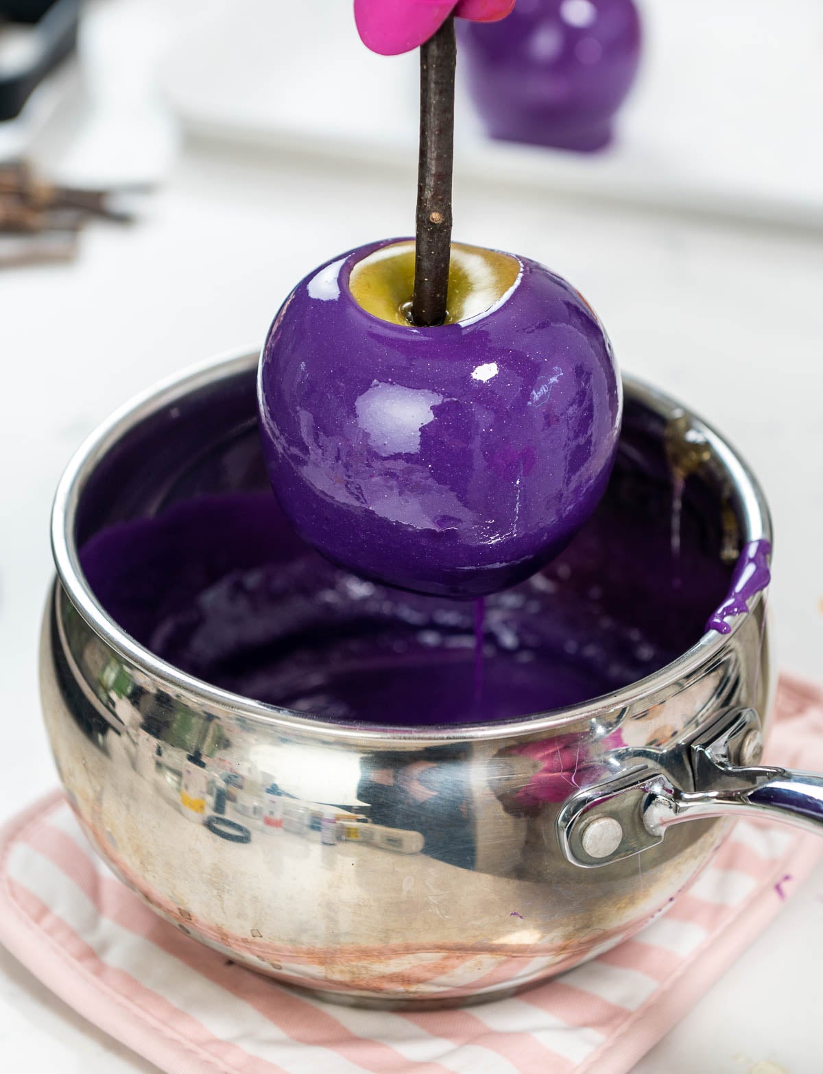 Apple dipped into a purple candy coating.