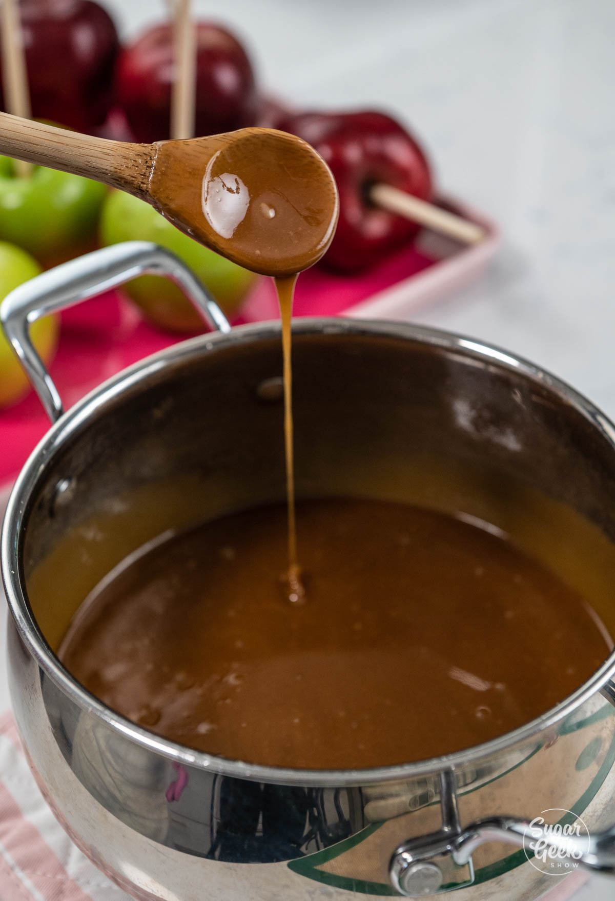 closeup of finished homemade caramel dripping from a spoon