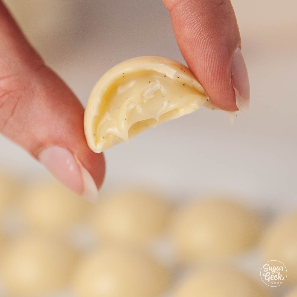 close up of white chocolate bon bon filled with white chocolate ganache