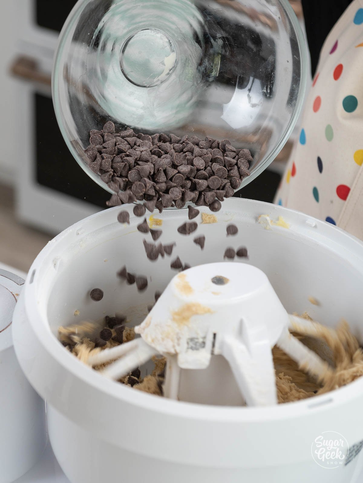 adding chocolate chips to mixer