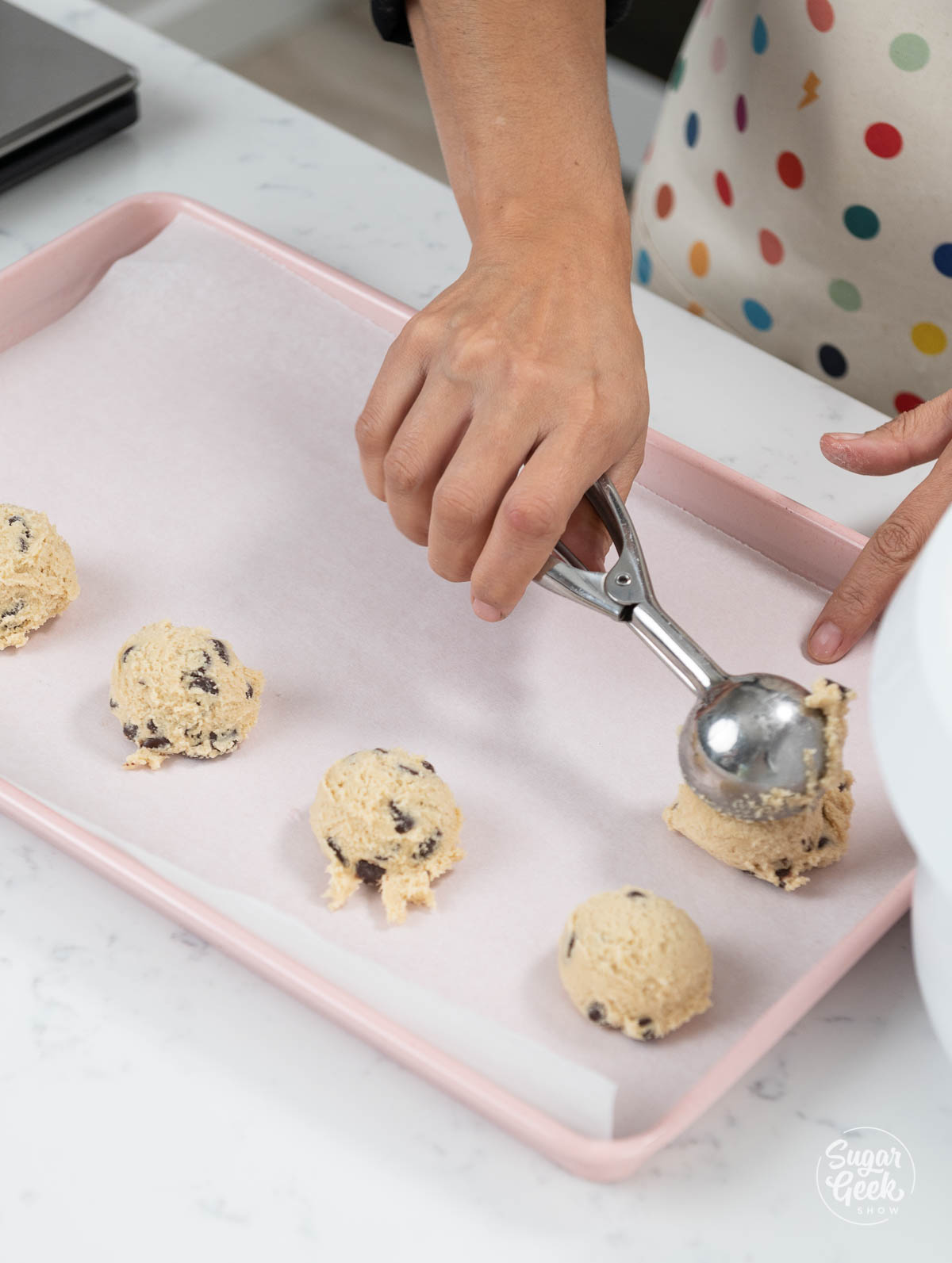 scooping cookie dough onto the sheet pans