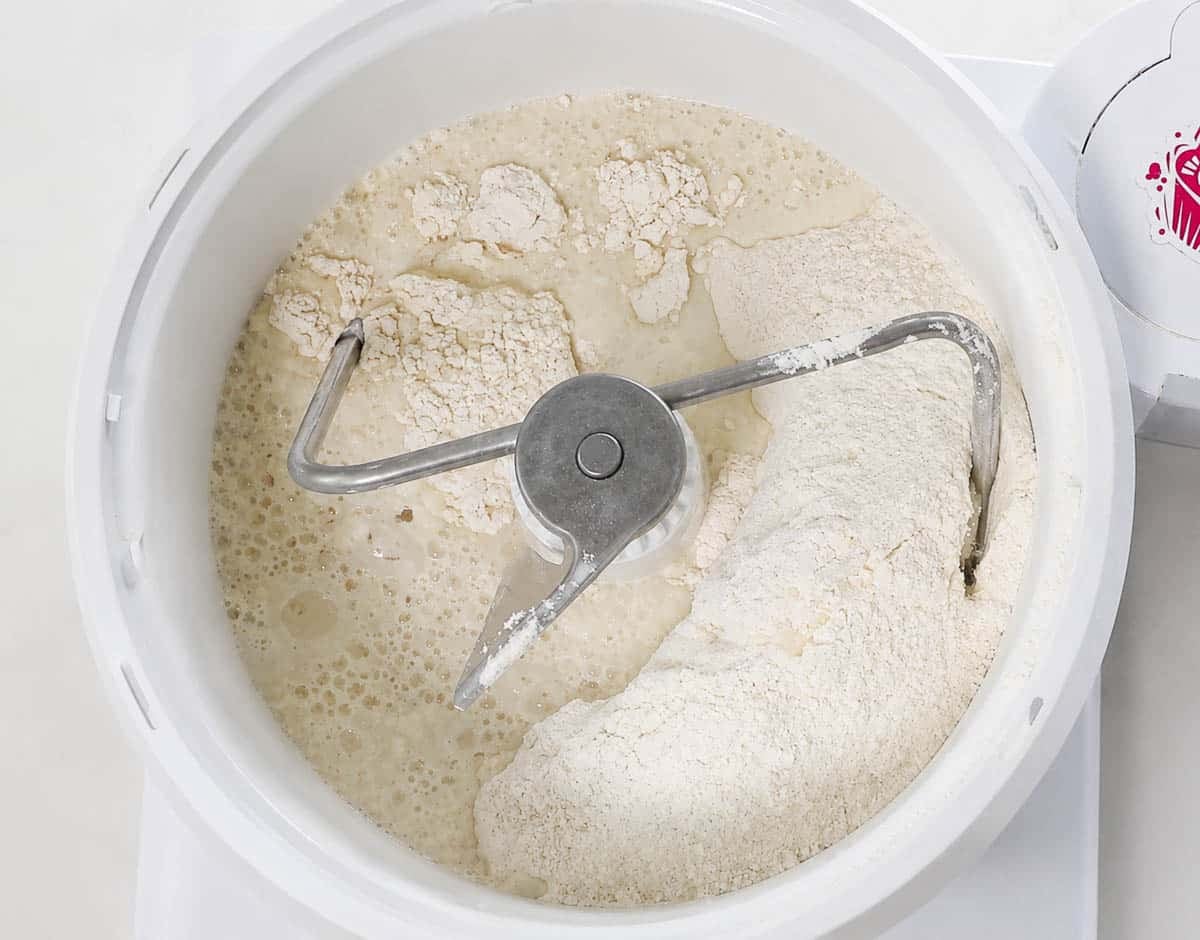 Bread ingredients in the bowl of a stand mixer.
