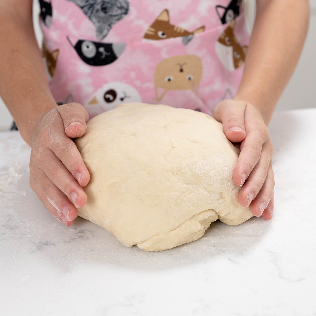shaping bread dough into a smooth ball