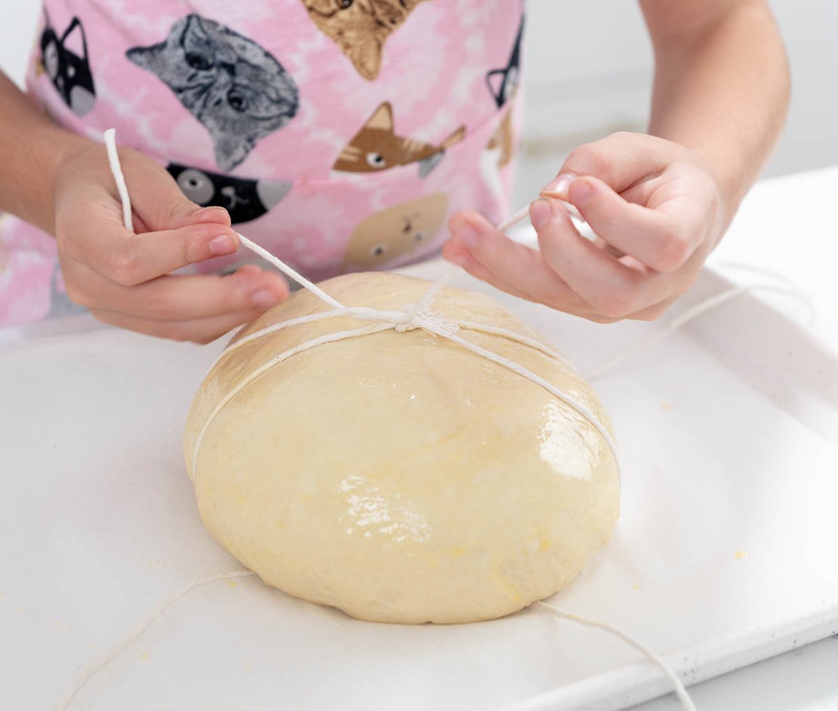 tying bakers twine around bread dough