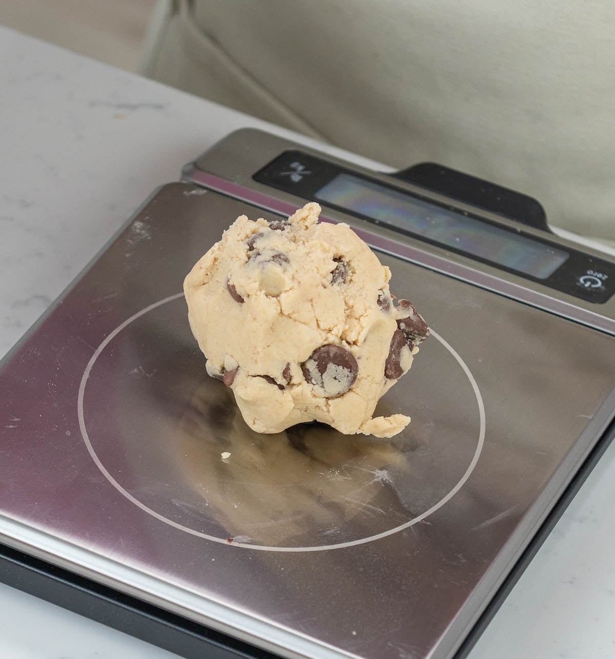 cookie dough ball on a food scale