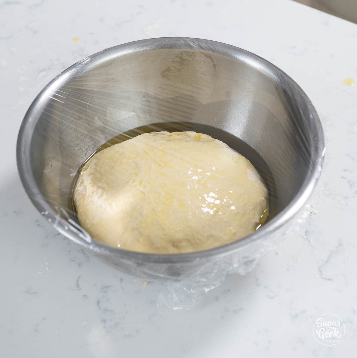 focaccia bread dough in a bowl with olive oil