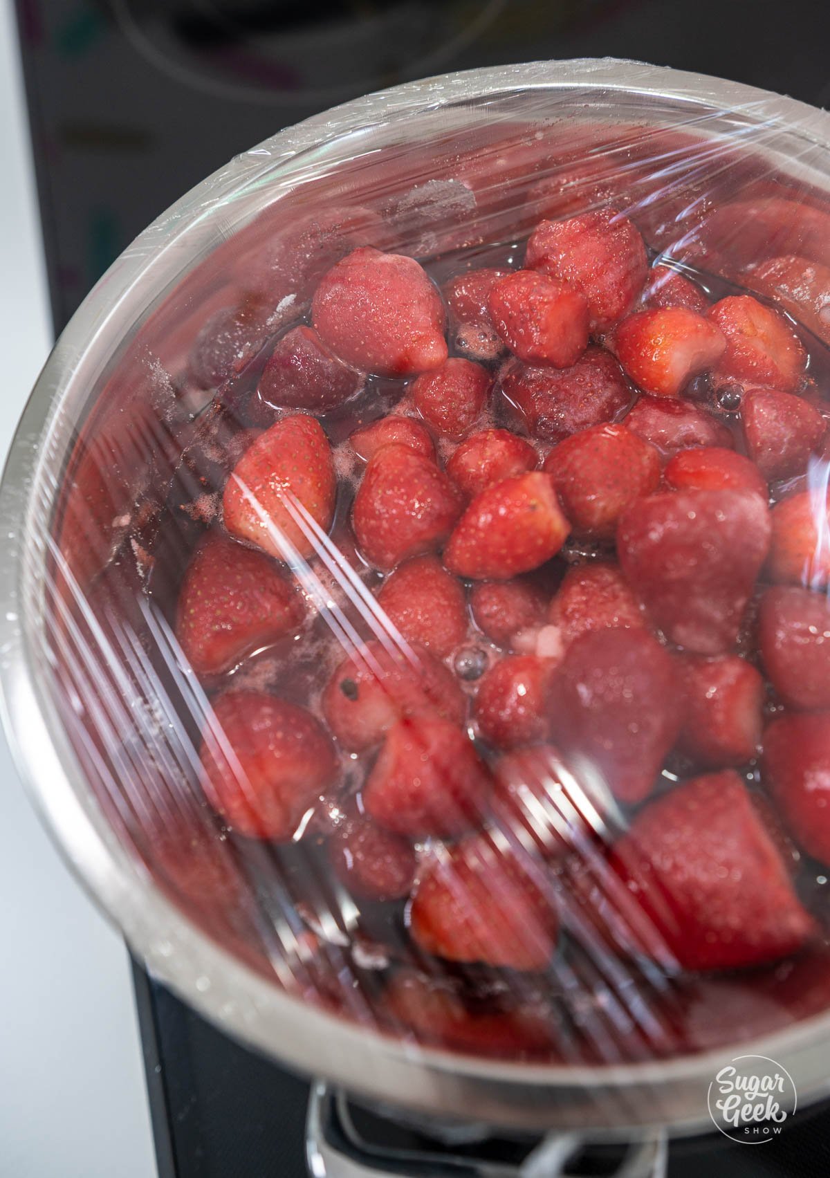 top down view of strawberries inside bowl sitting inside strawberry juice