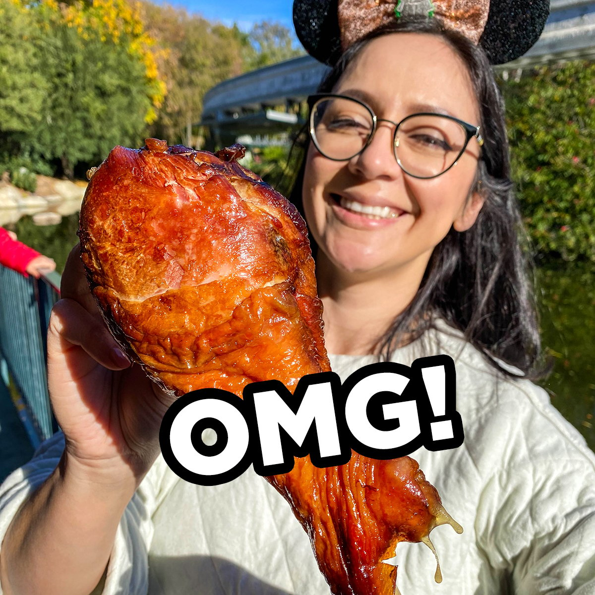 woman holding a giant turkey leg in disneyland