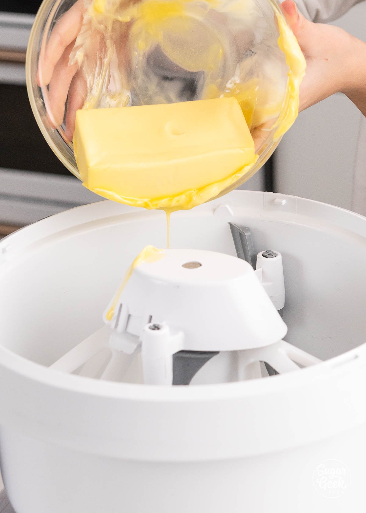 adding butter to a mixing bowl