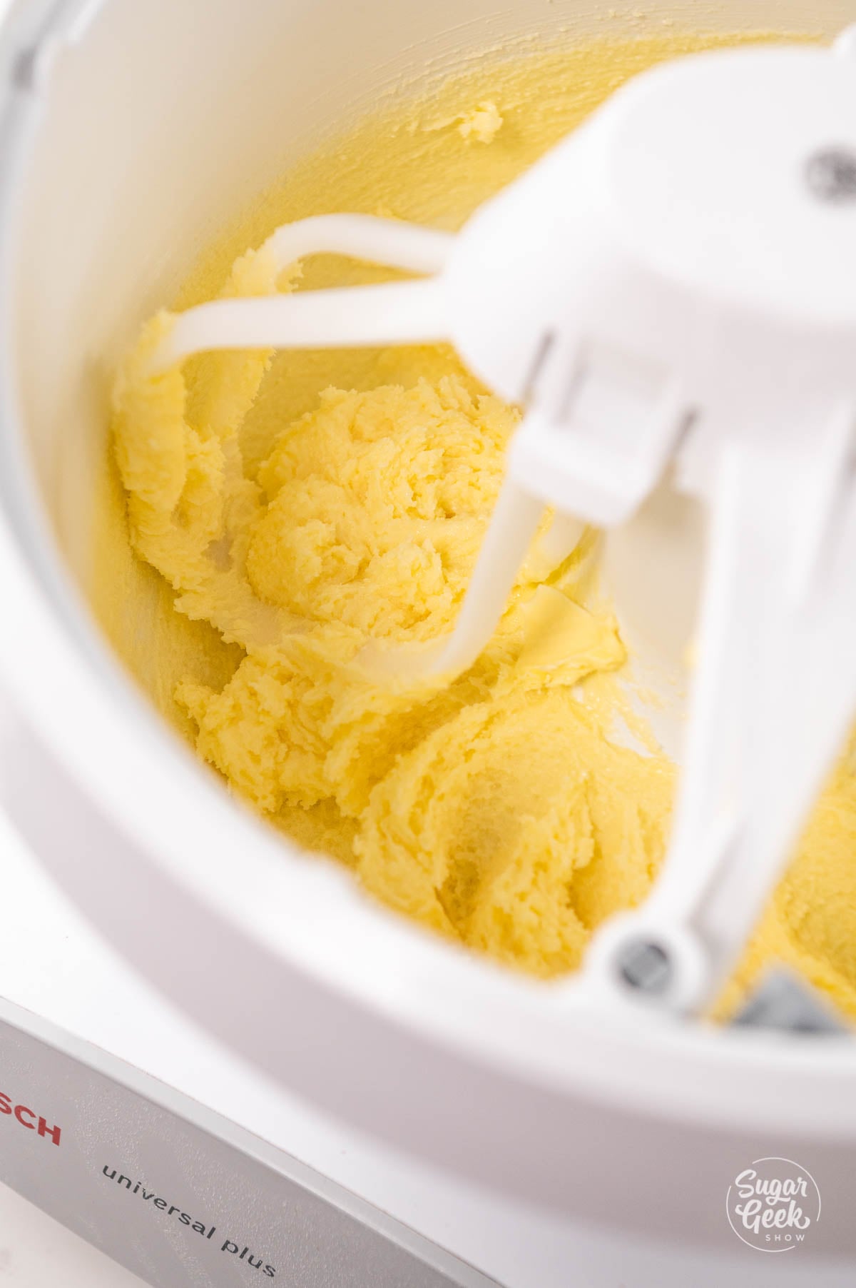 Creamed butter in the bottom of a mixer bowl.