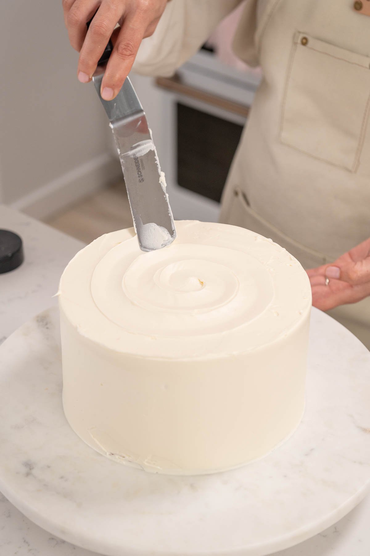 using an offset spatula to smooth buttercream