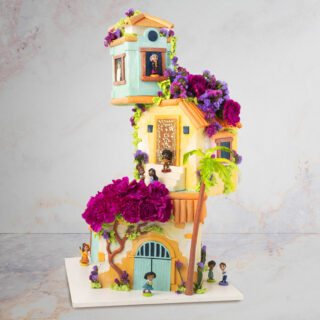 Cake sculpted to look like a gravity-defying house in the Disney movie Encanto