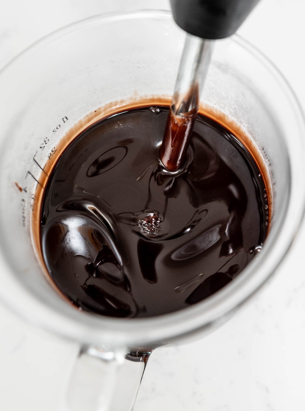 immersion blender inside of chocolate glaze