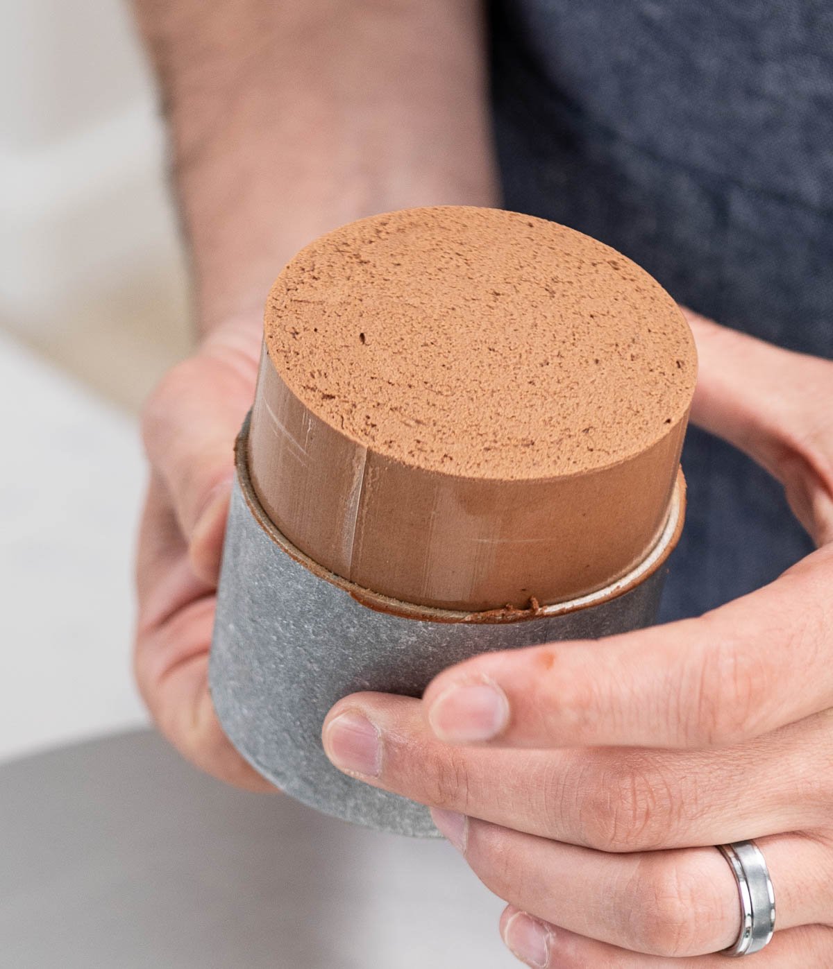 removing the chocolate entremet from a pan