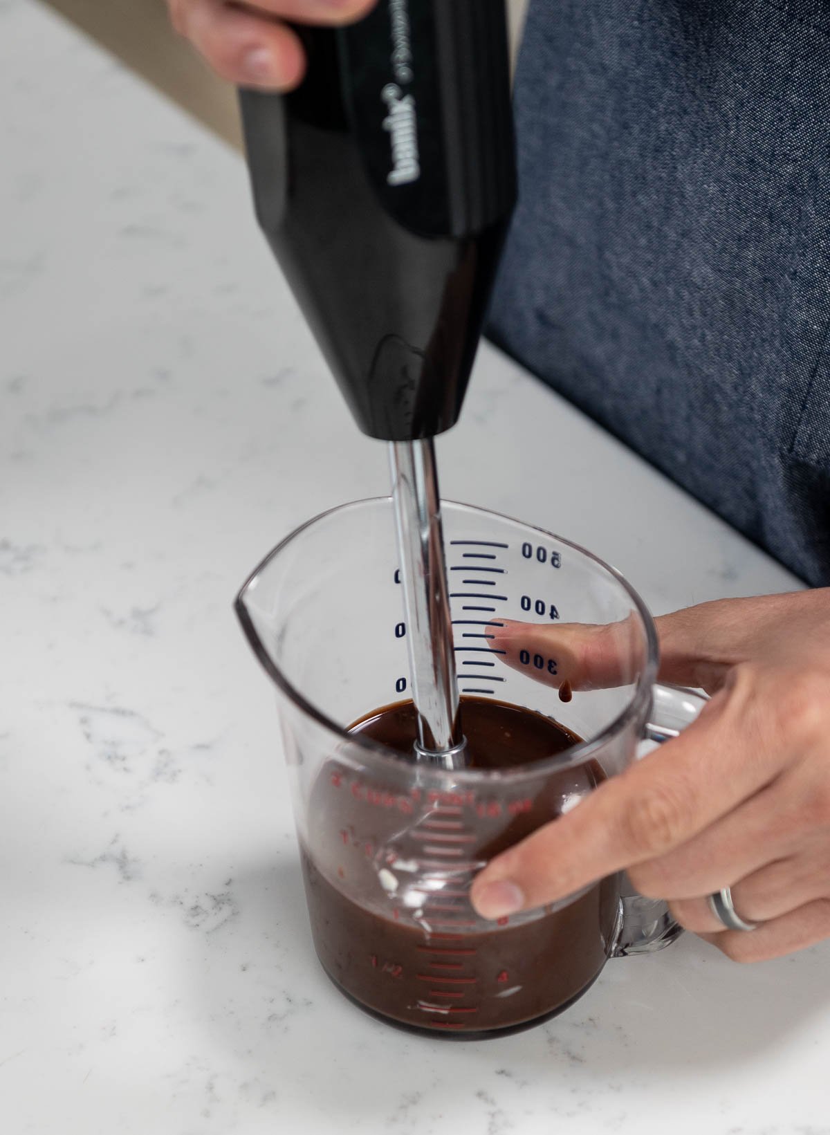 immersion blender inside of pitcher with chocolate