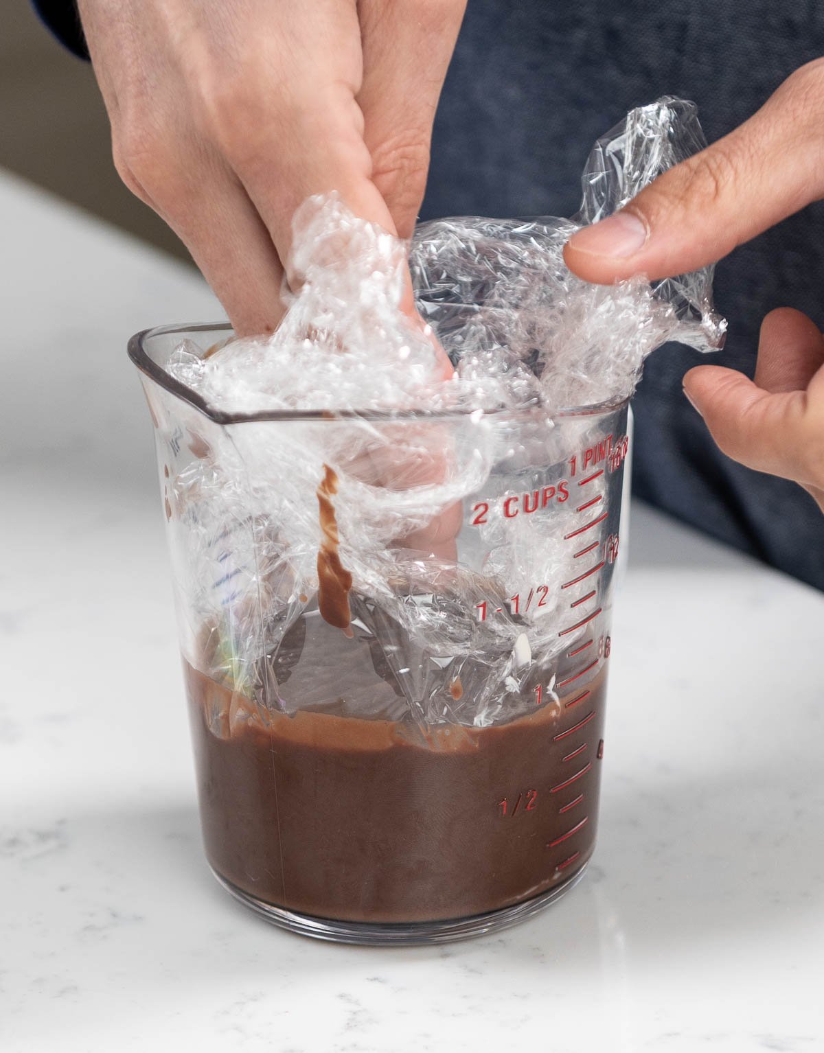 placing plastic wrap inside of pitcher