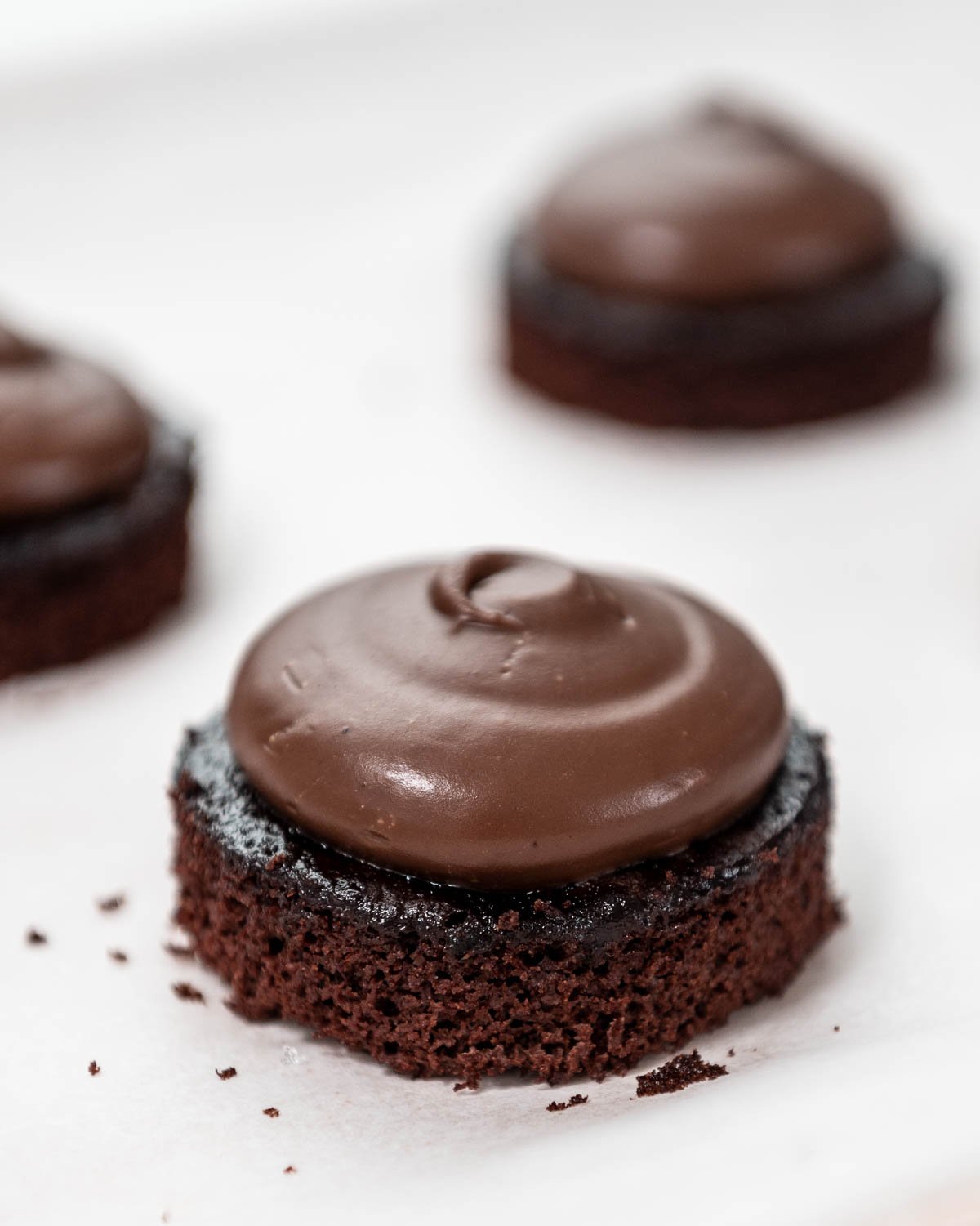 chocolate cake round topped with chocolate ganache