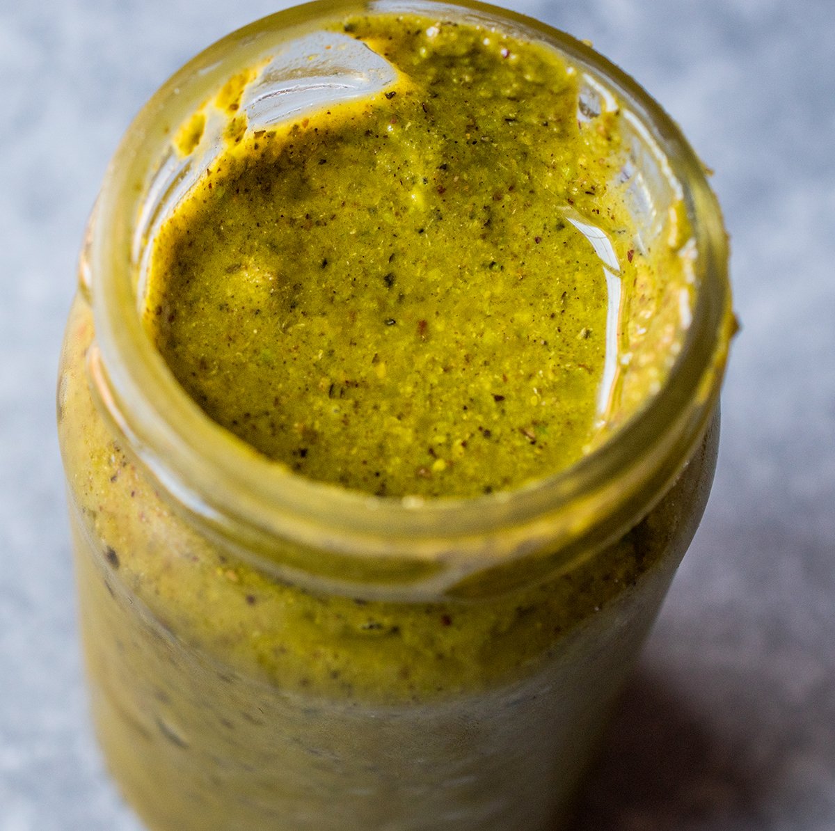 close up of pistachio butter in a jar