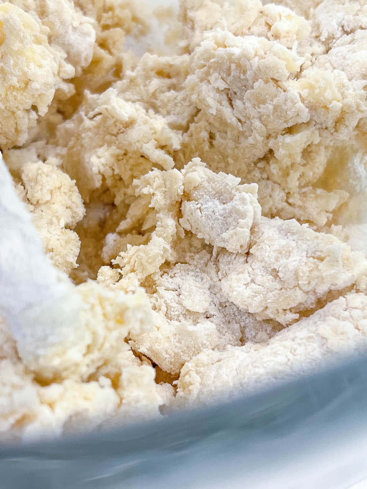 close up of tart crust dough mixed together in a bowl
