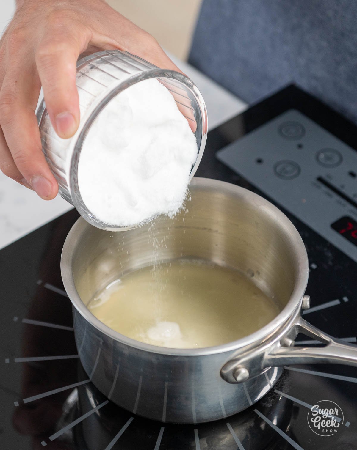 pouring sugar into sauce pan