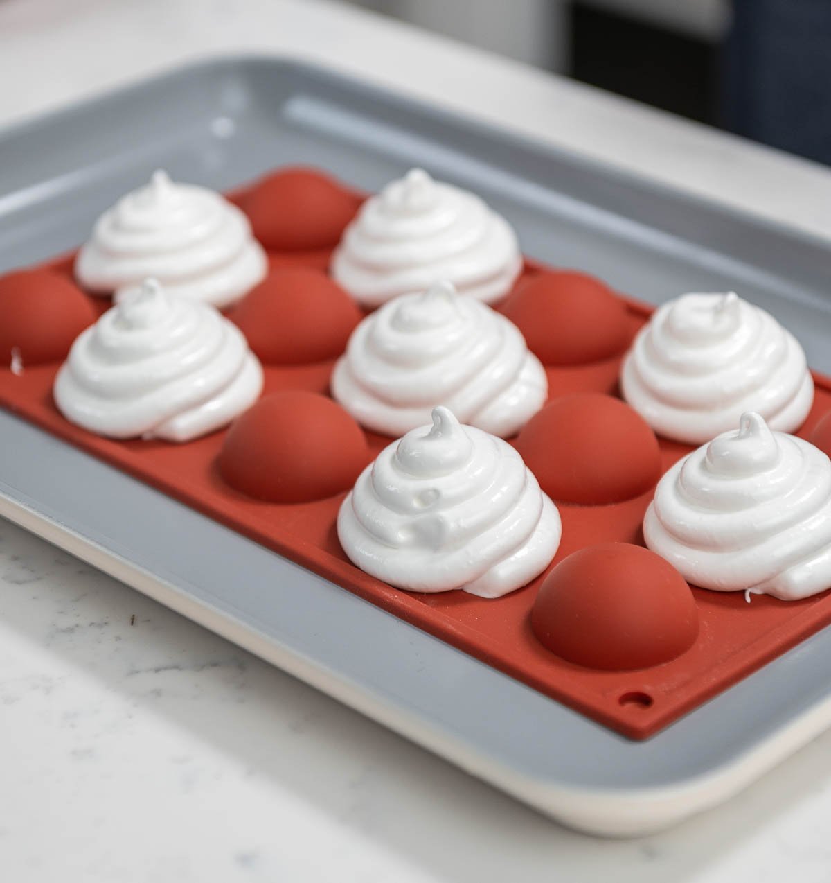 mini pavlova piped onto the back of every other alternating sphere silicone mold