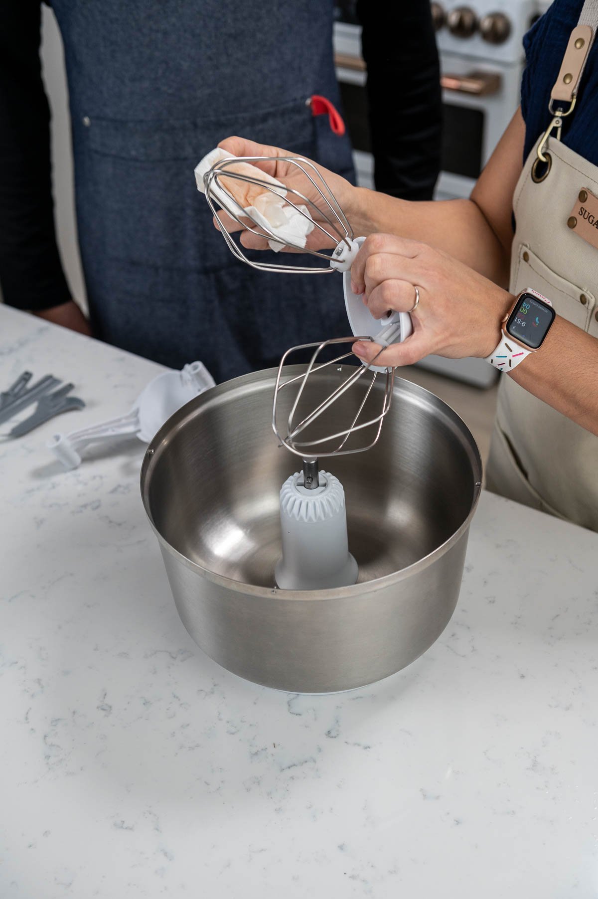hands holding whisk attachments