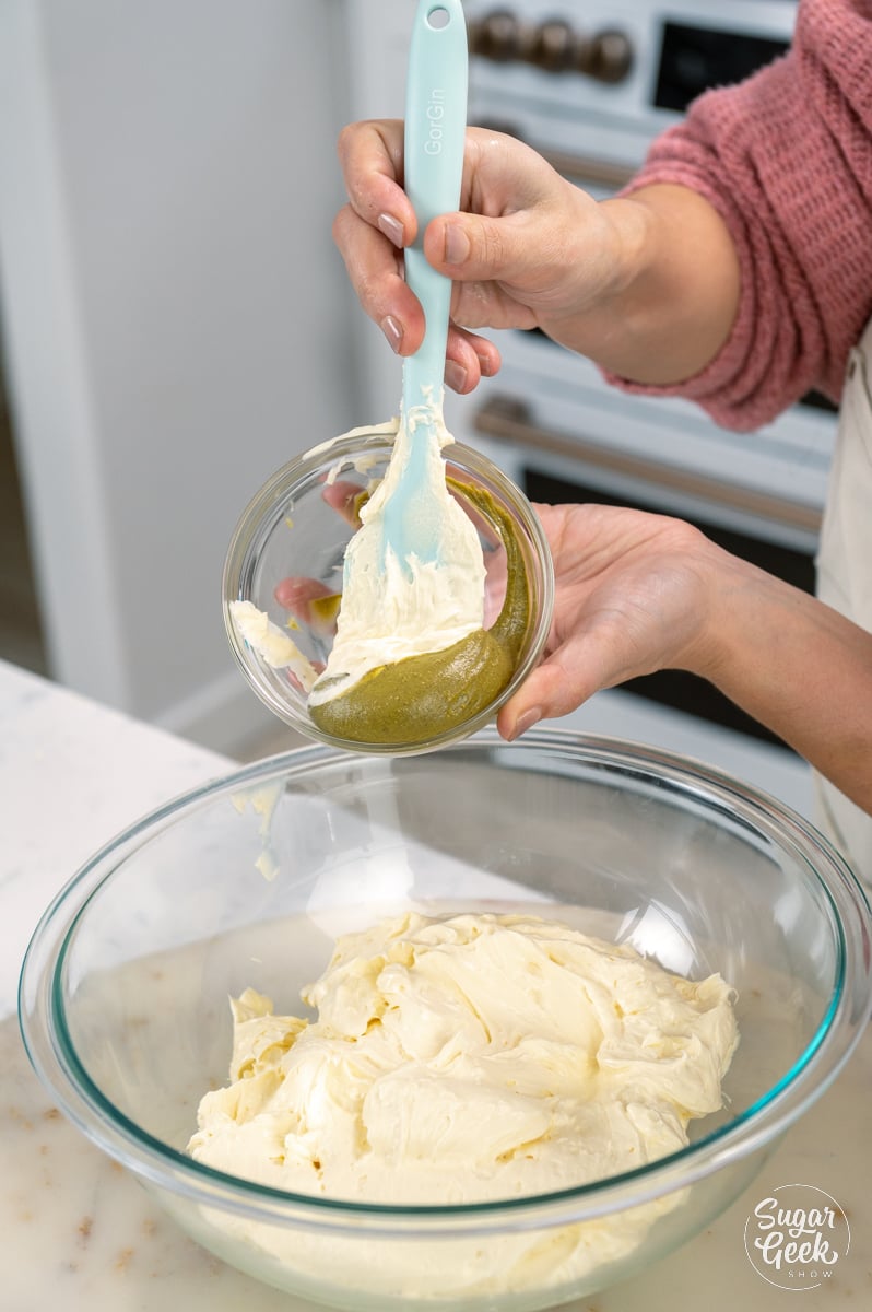 adding pistachio paste to french buttercream