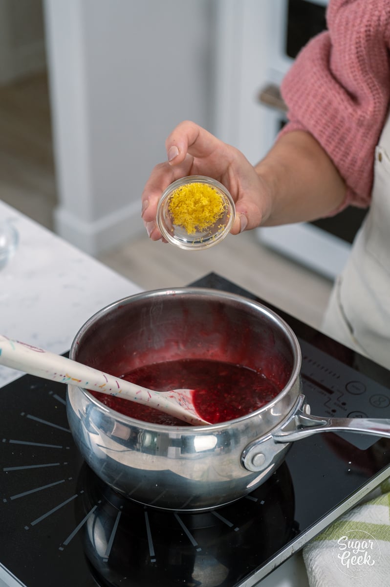 adding lemon zest to raspberry mixture
