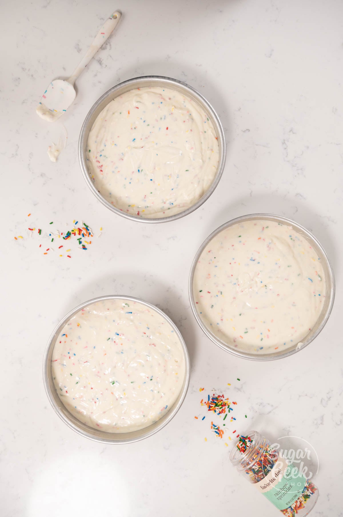 three cake pans with cake batter inside