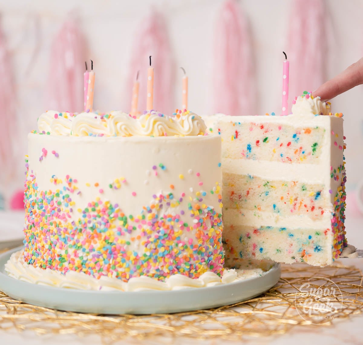 funfetti cake decorated in white frosting and sprinkles