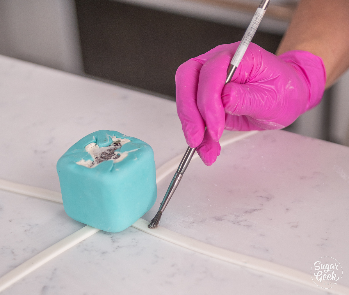 painting fondant with water using a brush