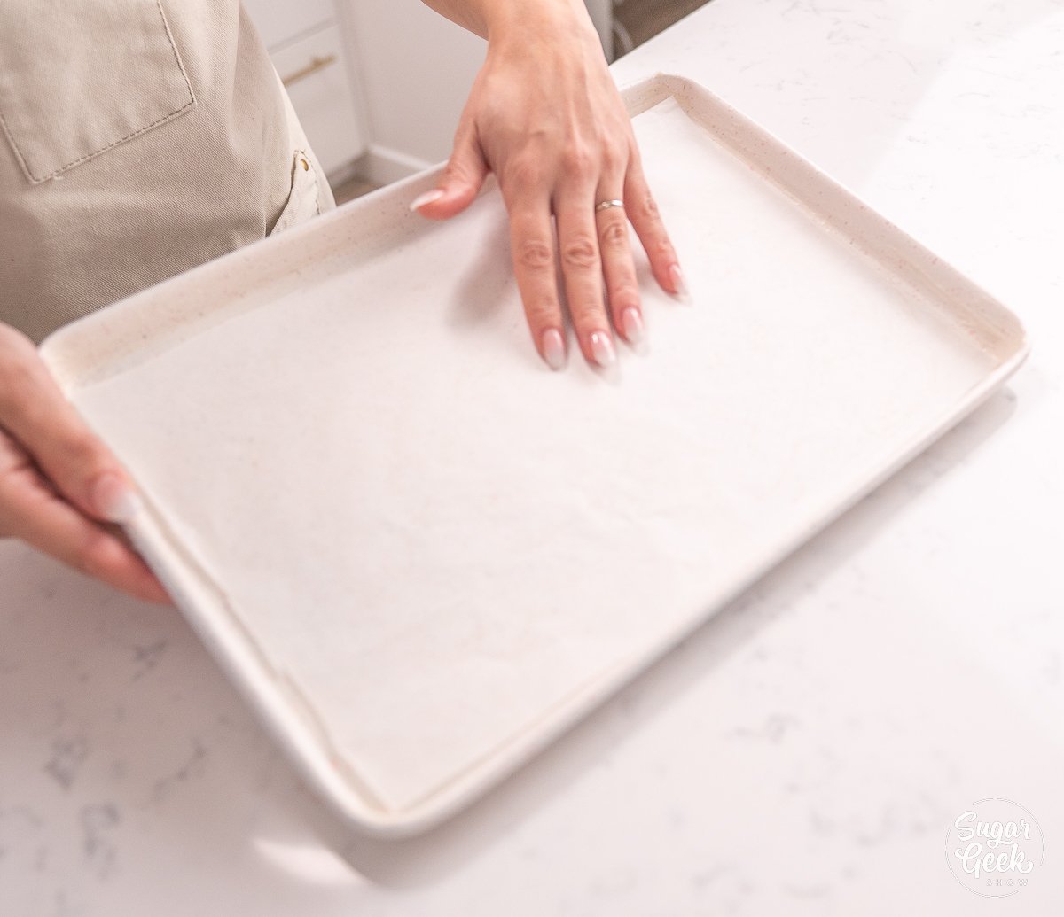hand placed on parchment paper inside baking sheet