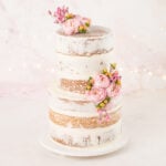 naked wedding cake decorated with flowers