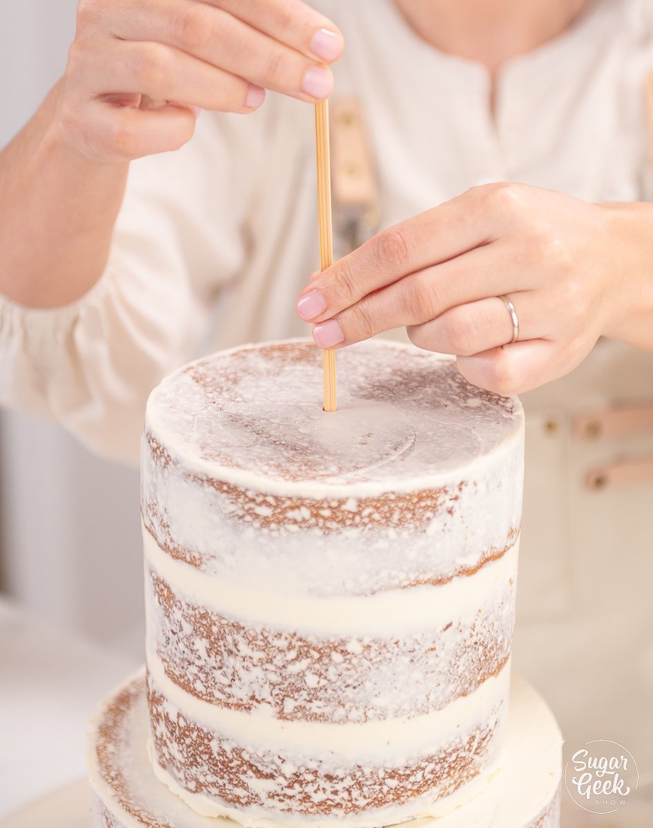 placing skewer into center of cake