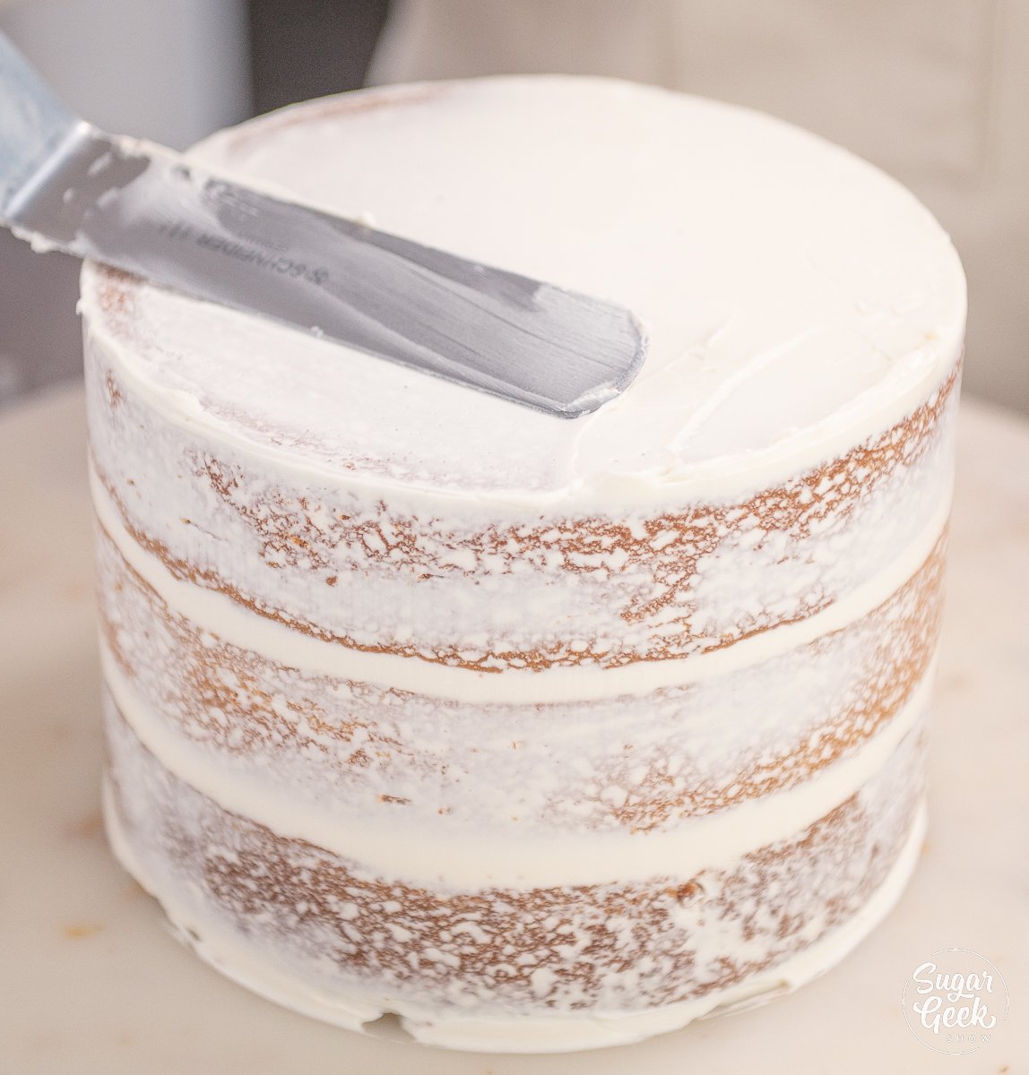 spatula on top of frosted cake
