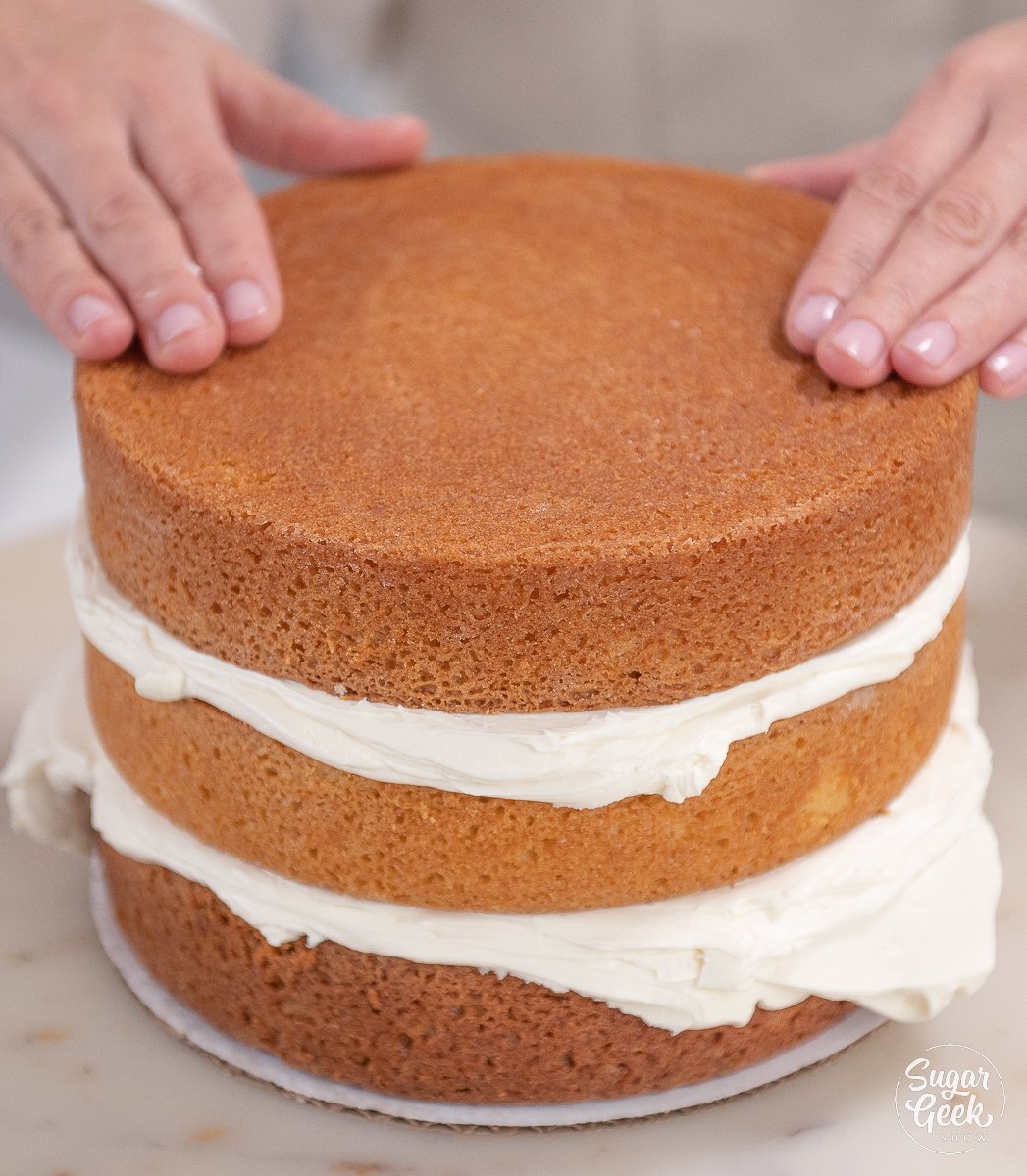 hands touching top cake layer