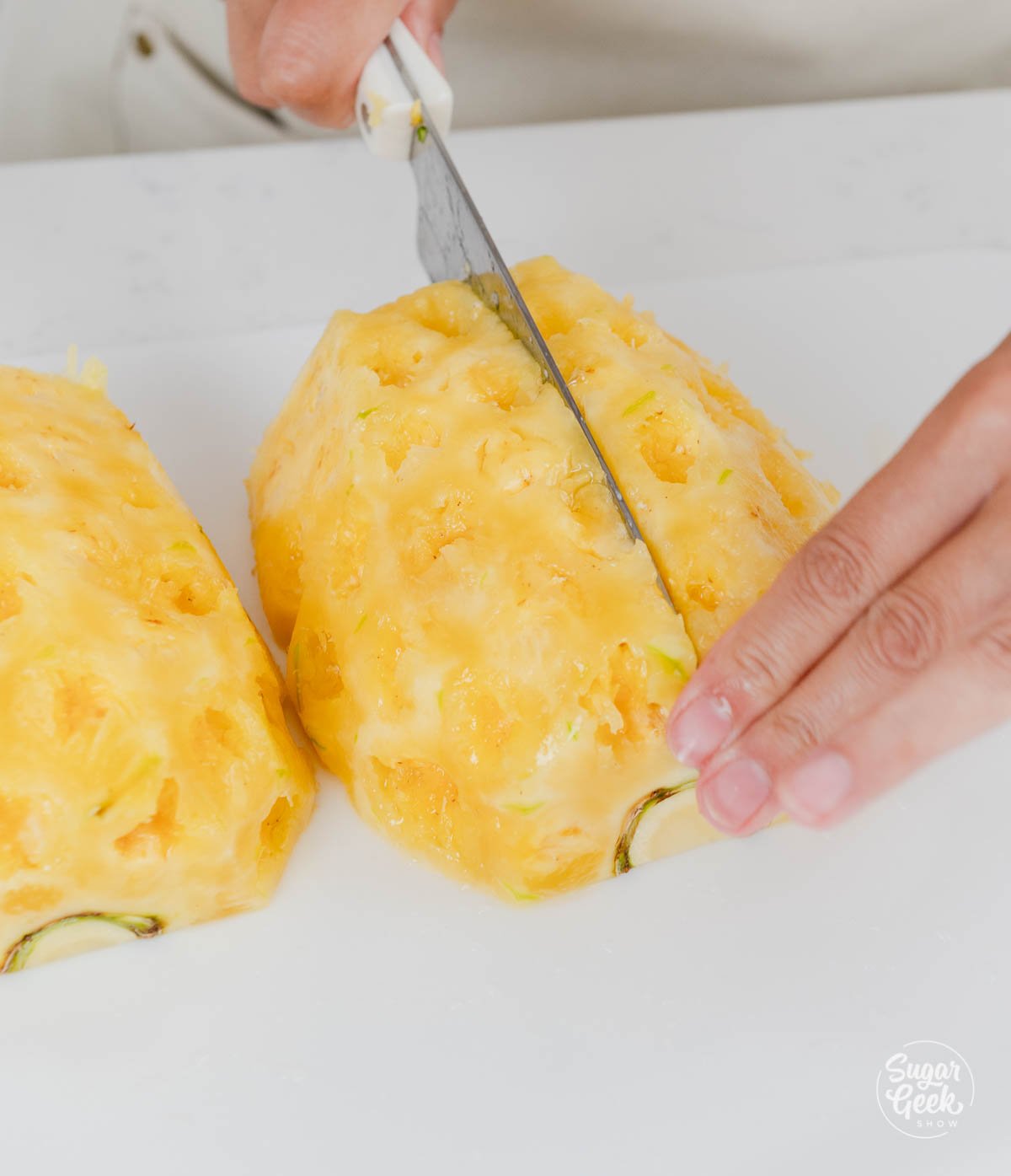 hands using knife to cute pineapple. 