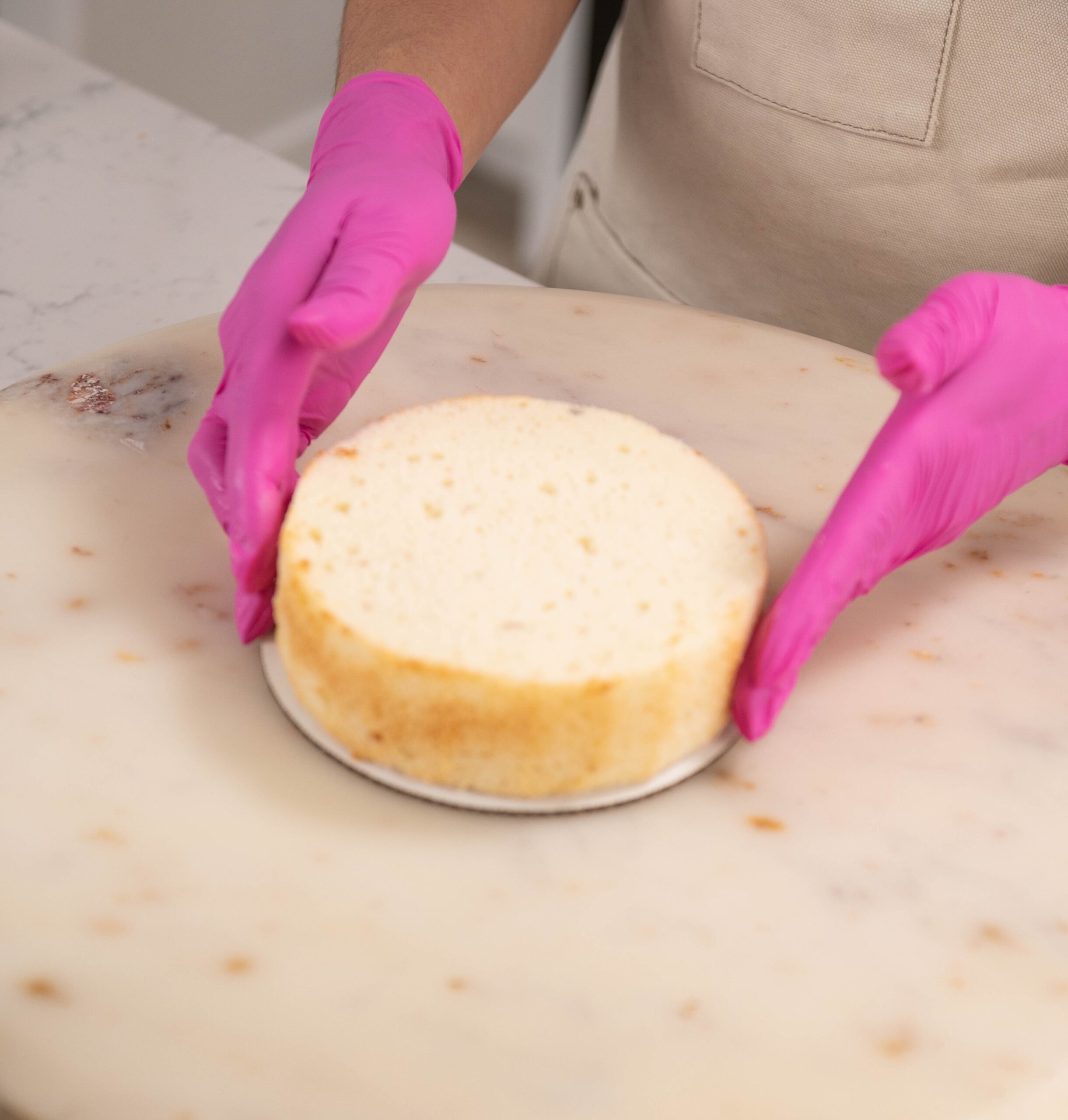hand placing cake layer on to cake board