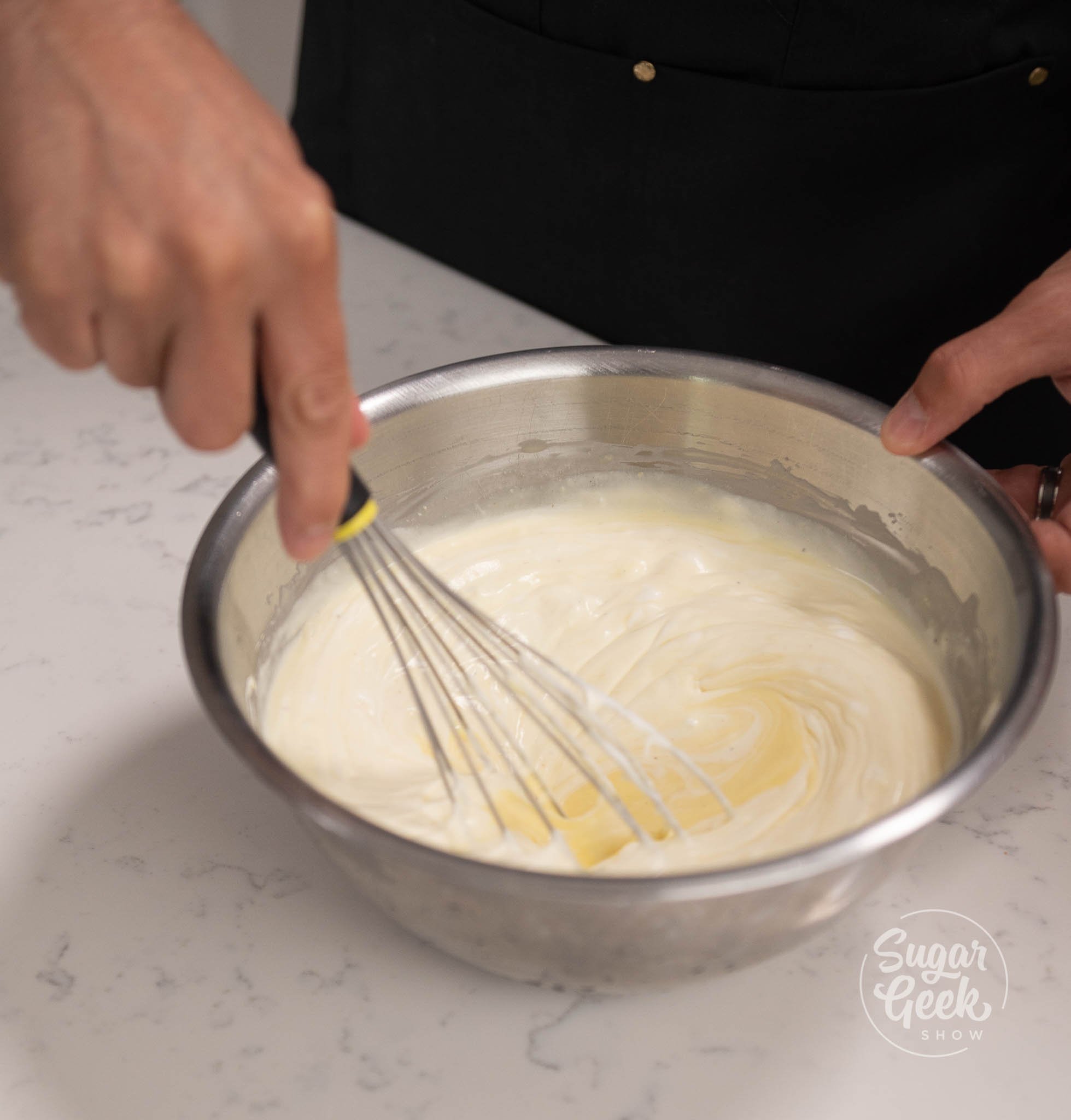 hand using whisk to whisk mousse