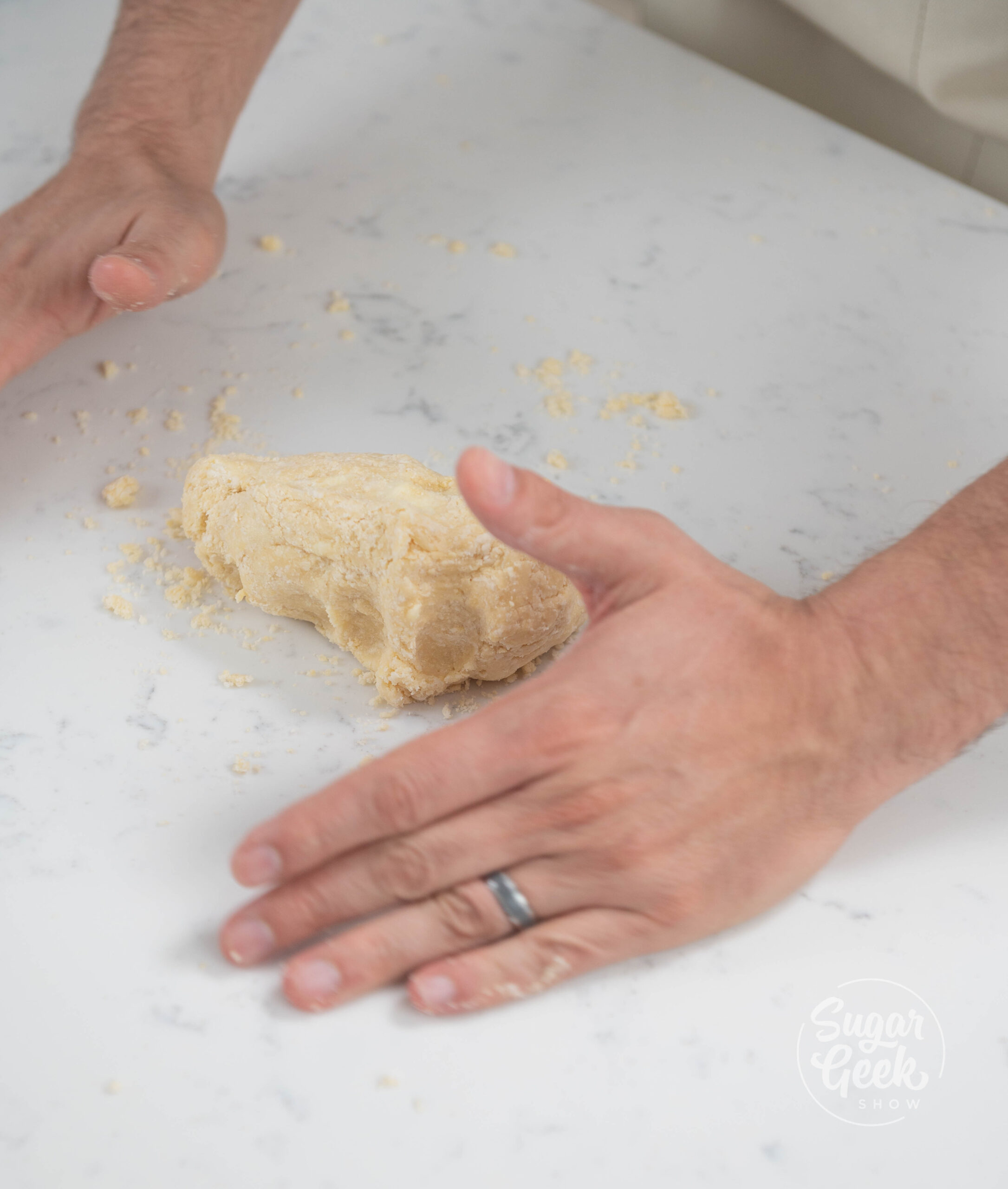 hands kneading dough.