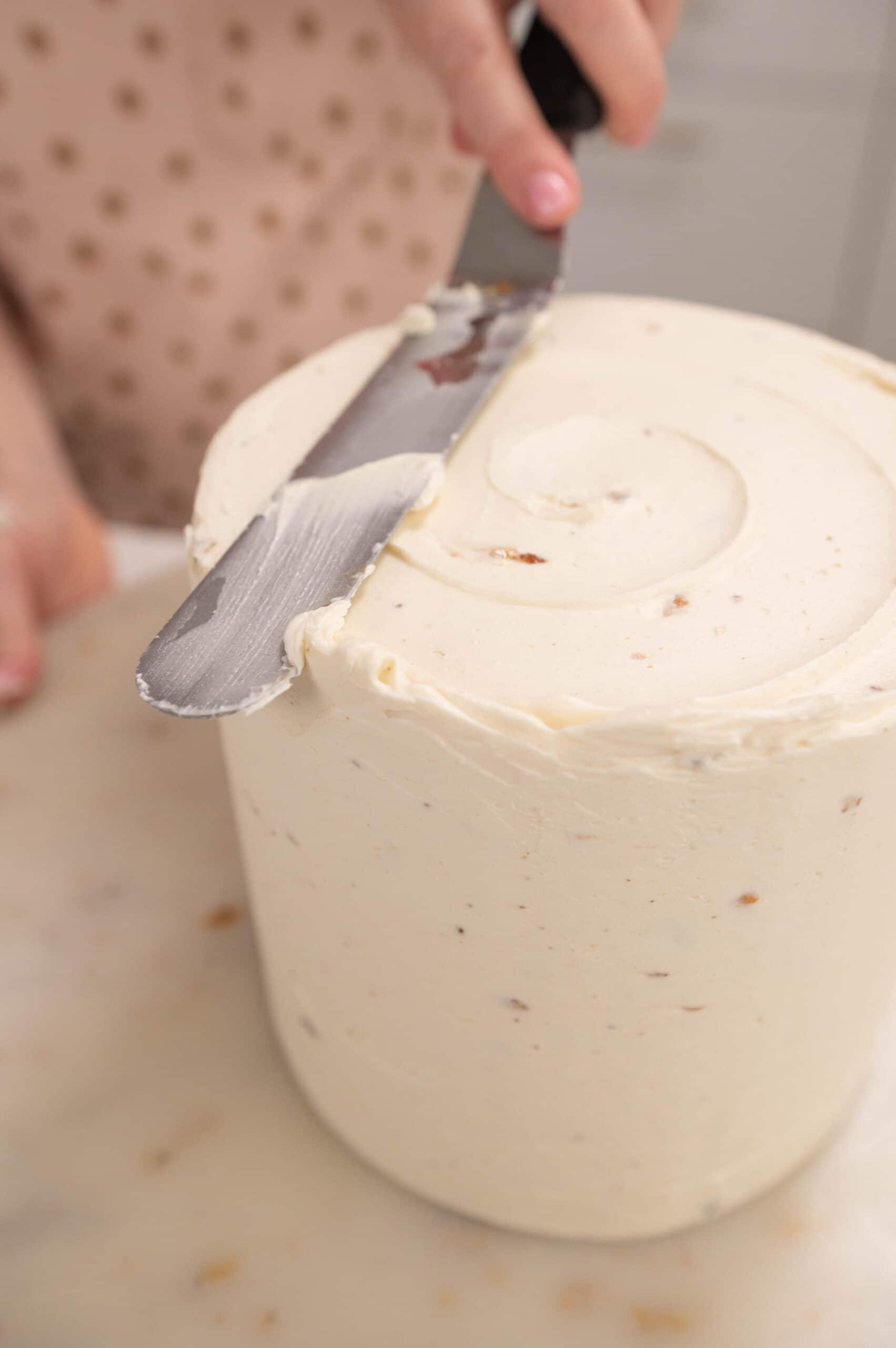 adding the final coat of buttercream with an offset spatula