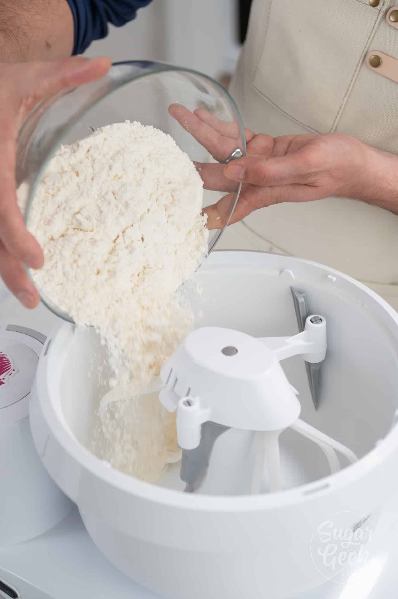 bowl of flour being added to stand mixer.