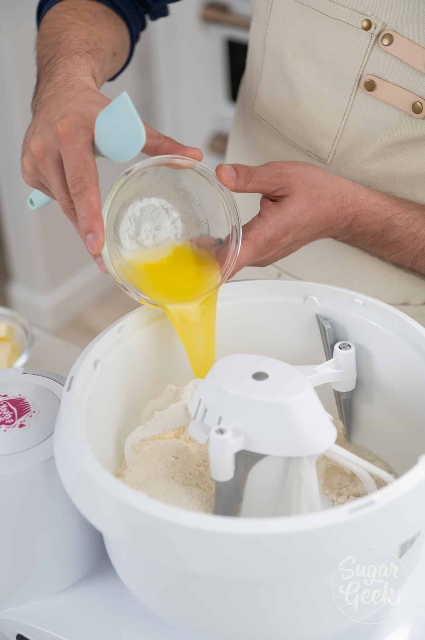 bowl of eggs being added to stand mixer.