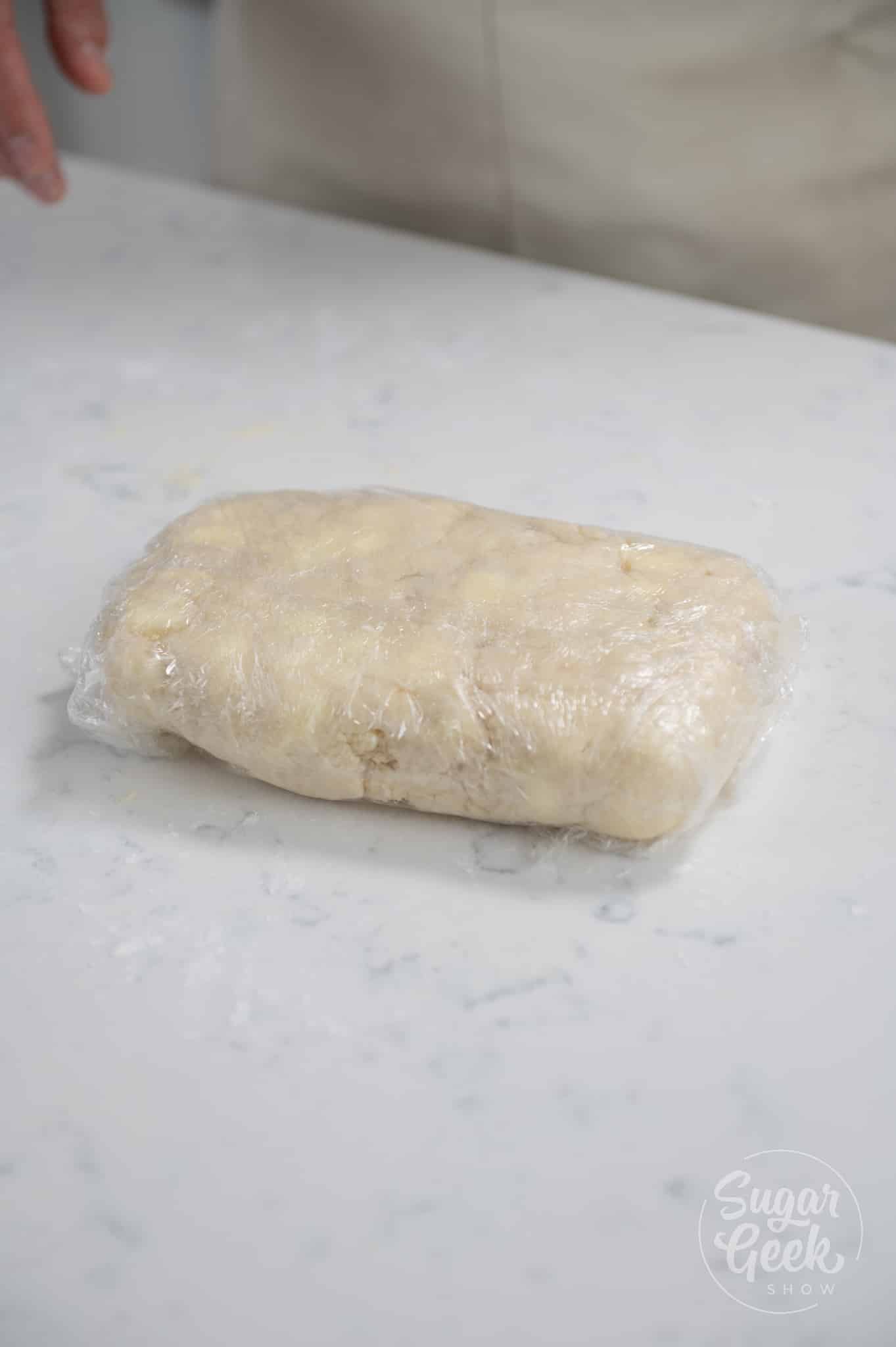 picture of plastic wrapped dough.