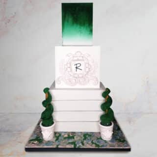 Stacked cake with homestead-style textures and topiary treats