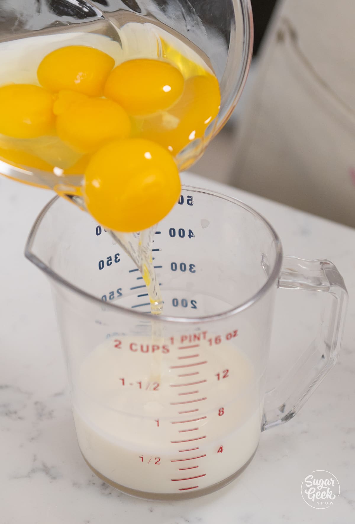 picture of eggs being added to milk. 